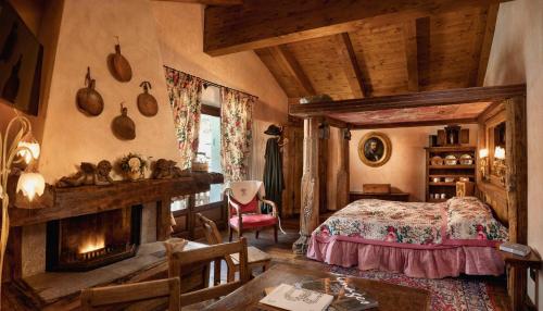 a bedroom with a bed and a fireplace at Bellevue Hotel & SPA in Cogne