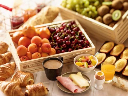 a table topped with lots of different types of food at ibis Hyeres Centre in Hyères