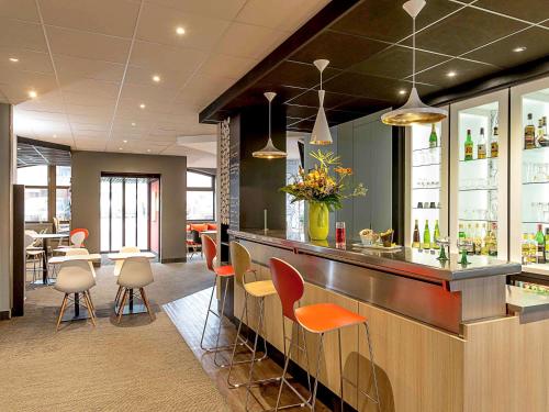 a kitchen with a large counter top and a large window at ibis Colmar Centre in Colmar