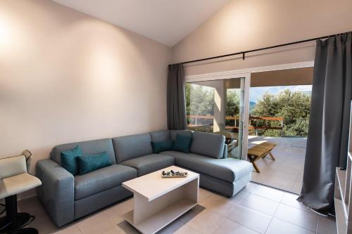 a living room with a couch and a table at ANATOLI VILLAS in Nikiana