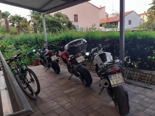 a group of motorcycles parked under a porch at Bed and Breakfast Villa Kristina in Rovinj