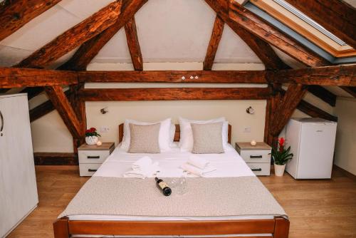 a bedroom with a large bed in a attic at Step to Kotor bay Guesthouse in Kotor