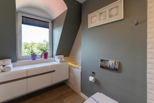 a bathroom with a sink and a window at Marina in Międzyzdroje