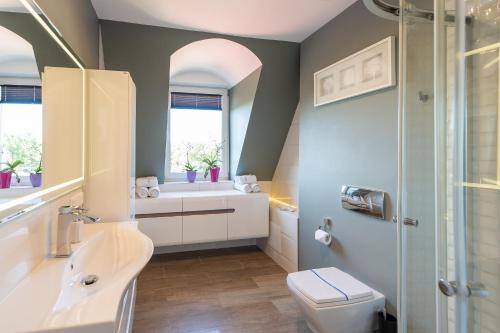 a bathroom with a sink toilet and a shower at Marina in Międzyzdroje