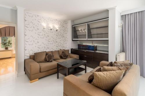 a living room with two couches and a table at Marina in Międzyzdroje
