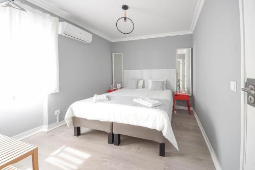 a white bedroom with a white bed in a room at Blue Door Lagos in Lagos