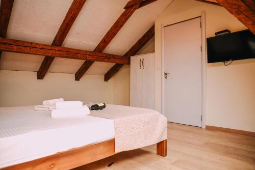 a bedroom with a bed and a flat screen tv at Step to Kotor bay Guesthouse in Kotor