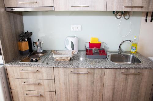 a kitchen with a sink and a counter top at Sweet Love Family in Coimbra