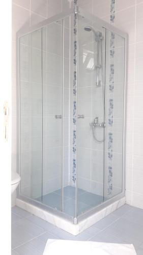 a shower with a glass door in a bathroom at Rota Hotel in Dalyan