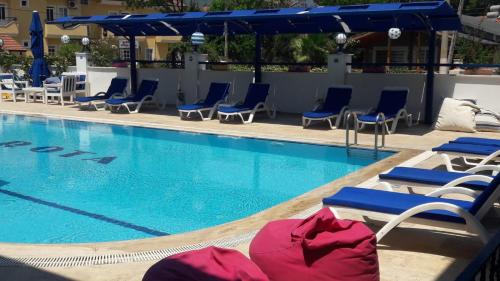 a swimming pool with lounge chairs and a swimming pool at Rota Hotel in Dalyan