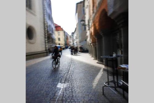 a person riding a bike down a city street at Gästehaus Kohlberg in Kohlberg
