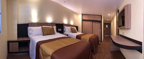 Ένα ή περισσότερα κρεβάτια σε δωμάτιο στο Hotel Casa Blanca Internacional
