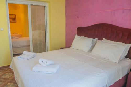 a bedroom with a large bed with towels on it at Hotel Astoria in Igoumenitsa