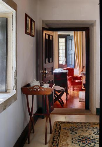 a room with a table and a living room at Quinta do Regalo in Coimbra