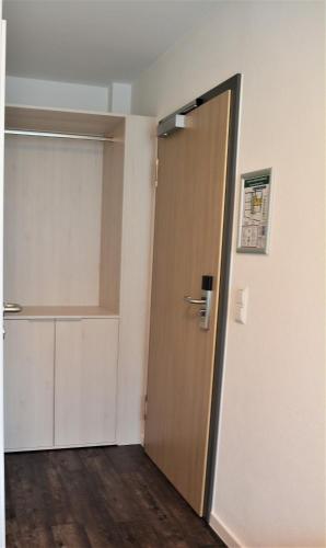 an empty room with a door and a closet at Hotel BaWü in Stuttgart