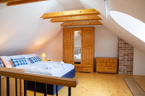 a bedroom with a bed in a room with stairs at Exklusives Landhaus in Šatov