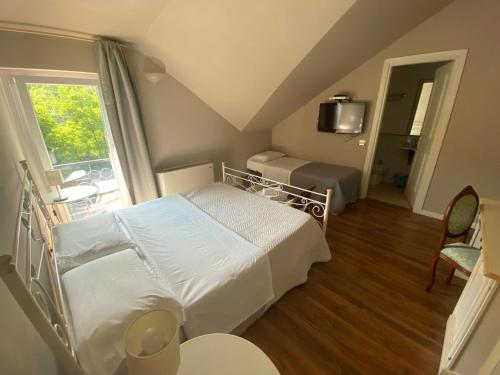 Ένα ή περισσότερα κρεβάτια σε δωμάτιο στο Hotel Edoné