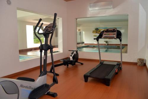 a gym with two exercise bikes and a swimming pool at Monte do Giestal - Casas de Campo & Spa in Abela