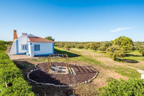 a view of a house with a playground at Monte do Giestal - Casas de Campo & Spa in Abela