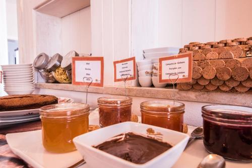 a counter with jars of honey and other food at Monte do Giestal - Casas de Campo & Spa in Abela