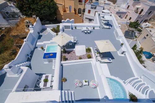 an overhead view of a blue house with a pool at Radiant Santorini in Mesaria