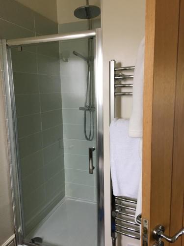 a shower with a glass door in a bathroom at 40 Bernisdale - The Sabhal in Skeabost