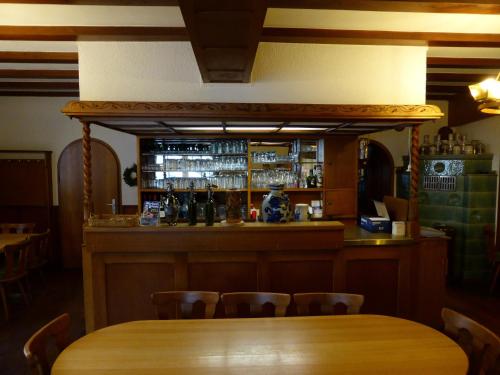 a bar in a restaurant with a wooden table and chairs at Zum Kaiserwirt in Heppenheim an der Bergstrasse