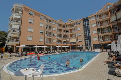a large swimming pool in front of a building at Apartment in Golem