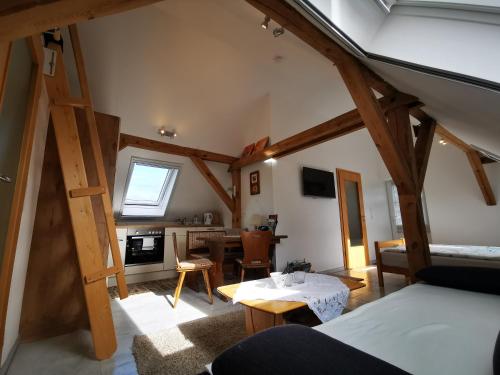 a kitchen and living room with wooden beams at Loft auf dem Land in Ludwigslust