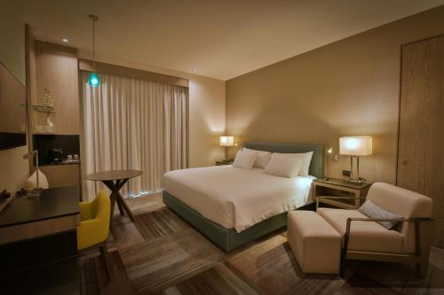 a hotel room with a bed and a chair at Casa Salles Hotel Boutique in Tequila