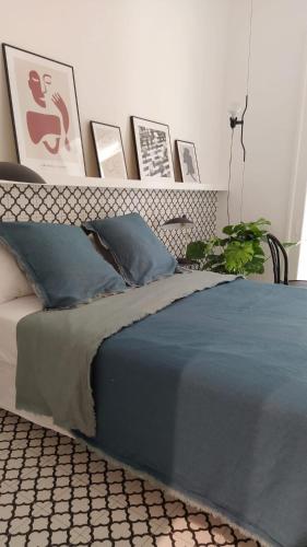 a bedroom with a bed with a headboard and pictures at Botteghelle14 suites in Salerno