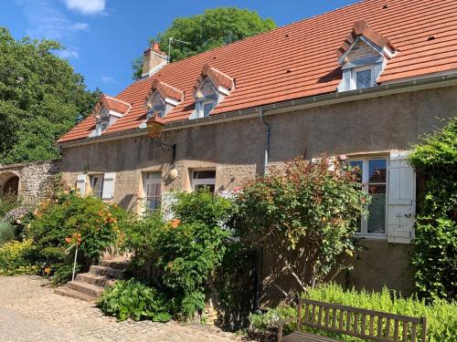 an old house with an orange roof at Domaine Les Bertrands in Couches