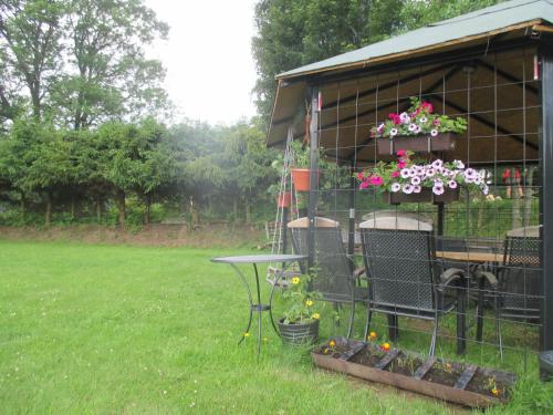 a building with a table and flowers in a yard at Chalupa u Matúšů Jeseníky in Dolní Moravice
