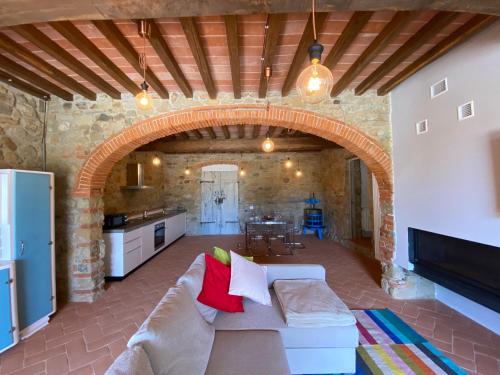 ein Wohnzimmer mit einem Sofa und einem Torbogen in der Unterkunft Il Cerro in Arezzo