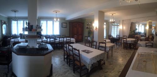 a restaurant with tables and chairs in a room at Mazmoura in Reignac-sur-Indre