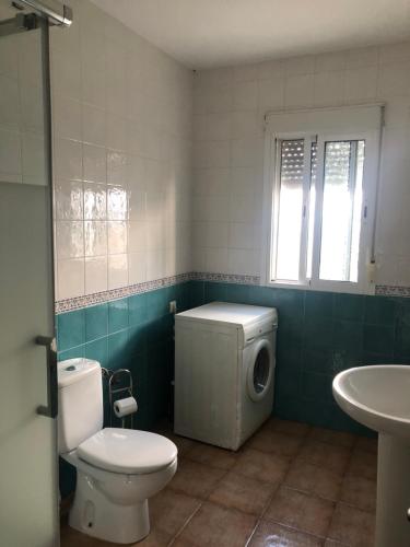 a bathroom with a toilet and a sink at Casas Juani- chalet con piscina in Conil de la Frontera