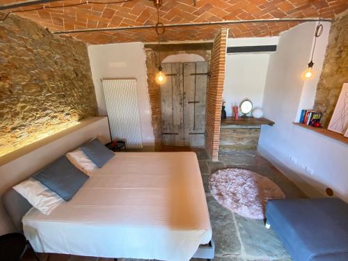 a bedroom with two beds in a stone wall at Il Cerro in Arezzo