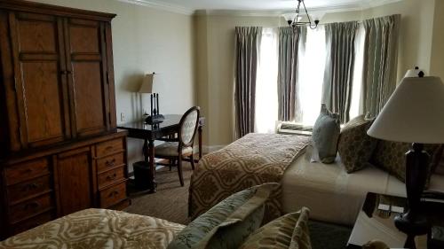 a hotel room with a bedroom with two beds and a desk at Chelsea Inn in San Francisco
