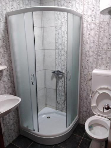 a shower stall in a bathroom with a toilet at Srebrna Nit in Veliko Gradište