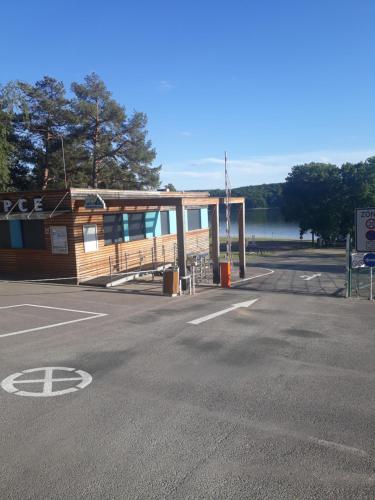 a parking lot with a building next to a lake at Chata Vranovská pláž in Štítary