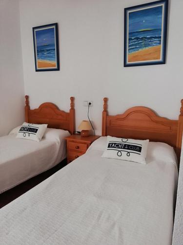 two beds in a room with two beds sidx sidx sidx sidx at Bungalow Arenales del Sol, Alicante in Arenales del Sol