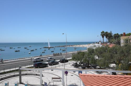 a view of a beach with boats in the water at Ocean View double Suite in Paço de Arcos