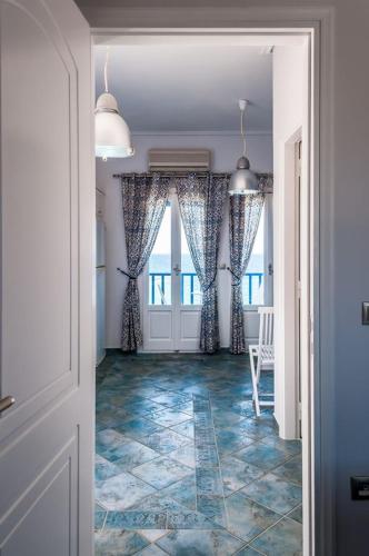 a hallway with a door and a floor with tiles at Aphrodite by Akroploro in Pollonia