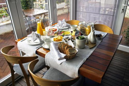 a table with a breakfast of food on it at Apartments Villa Azzurra Bol in Bol