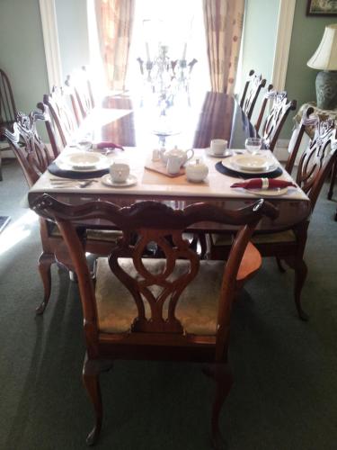 a dining room table and chairs with a table and a table at Belvedere House in Middleton in Teesdale