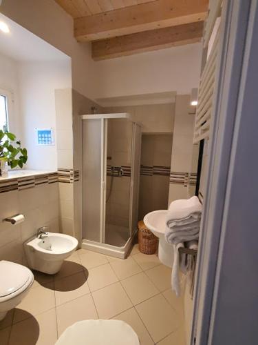 a bathroom with a shower and a toilet and a sink at Arco Della Neve Guest House in Bari