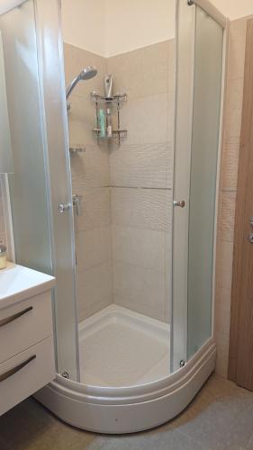 a shower with a glass door in a bathroom at Deluxe Apartment Joia with balcony near Old Town and Bacvice Beach in Split