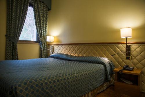 Postel nebo postele na pokoji v ubytování Hotel Giubileo
