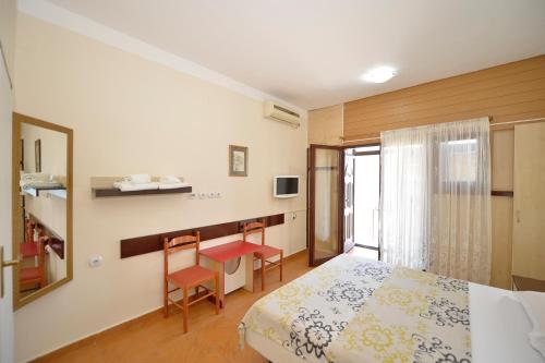 a bedroom with a bed and a table and chairs at Pana-Eustahije 253 in Kotor