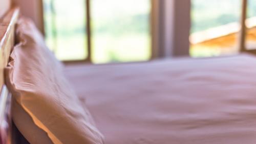 a close up of a pillow on a bed at Eco-Apartaments Cal Rossa de Taús in Taús